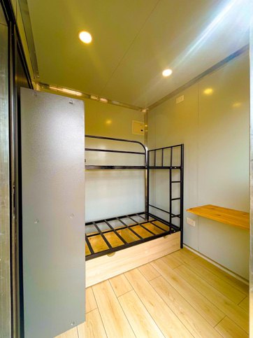 Accommodation unit with bunk bed and timber floor