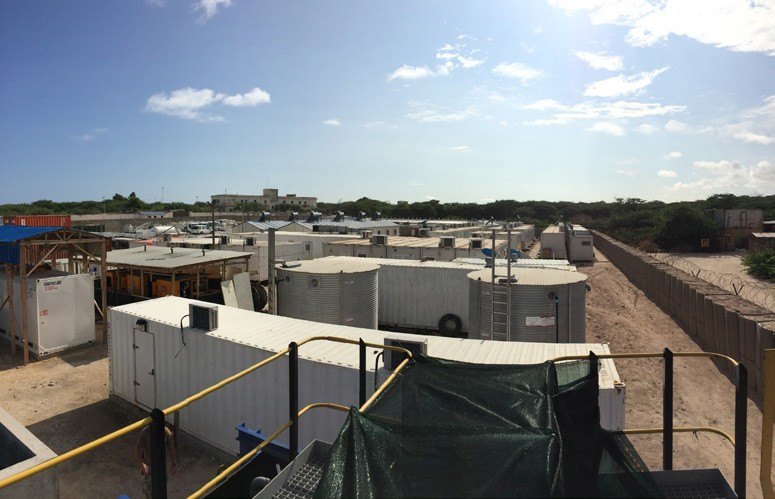 Modular camp units behind a perimeter fence